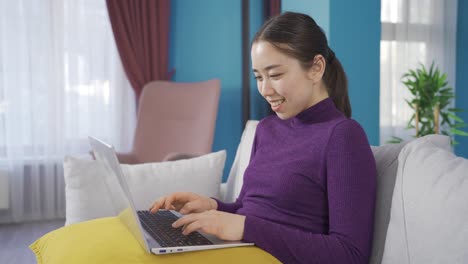 Asian-cute-woman-having-fun-and-laughing-talking-to-people-on-laptop.